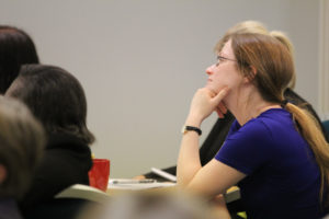 Audience members listening intently at Conference