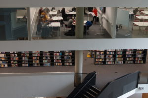 A view of the Learning Hub showing library shelves and a classroom