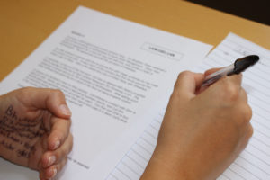 Student copying work written on their hand