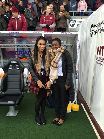 Students at the Northampton Town football ground