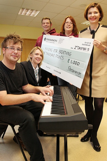Persimmon Homes Midlands Sales Manager Deborah Box and Sales Adviser Nicola Bond presenting a Community Champions cheque to Angela Prouse, James Wyatt and Chris Startup from Singing for Breathing at Parklands Community Centre