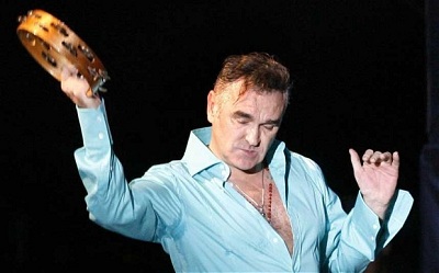 Morrissey performing with a tambourine