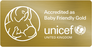 Logo for Accredited as Baby Friendly Gold, by unicef United Kingdom. The logo shows a woman breastfeeding a baby out of lines.