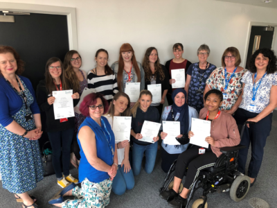 A group of students receive their British Sign Language certificates