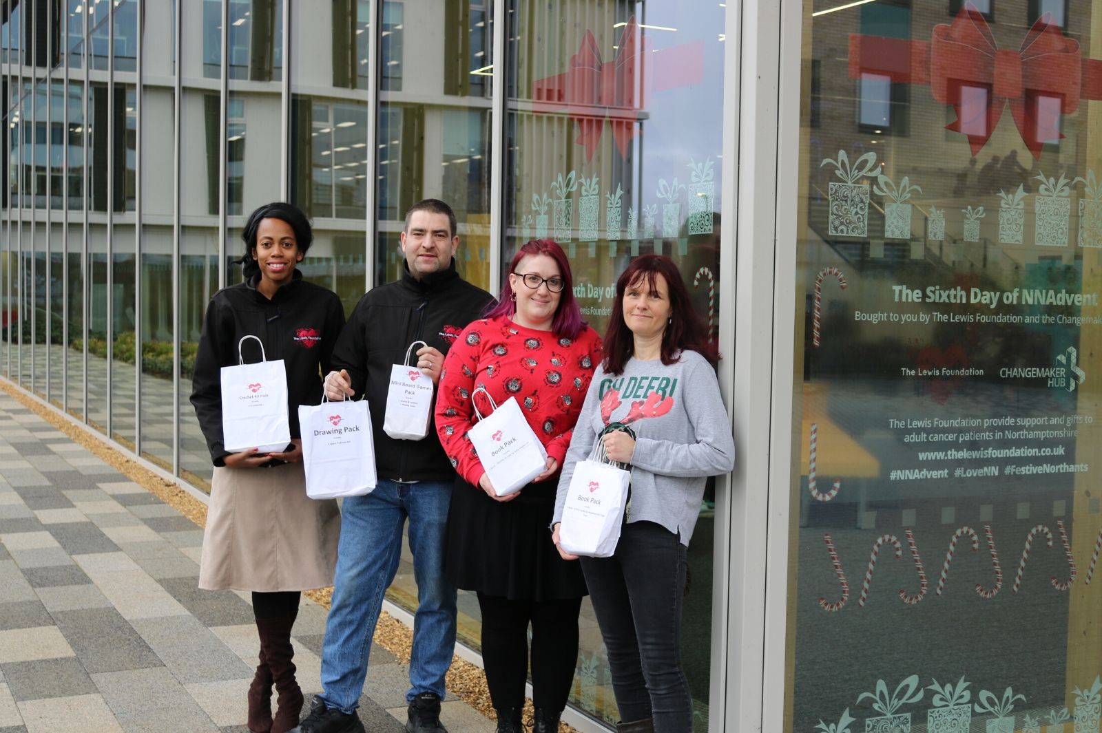 Photo of The Lewis Foundation and Changemaker staff outside the Learning Hub for the NN Advent campaign