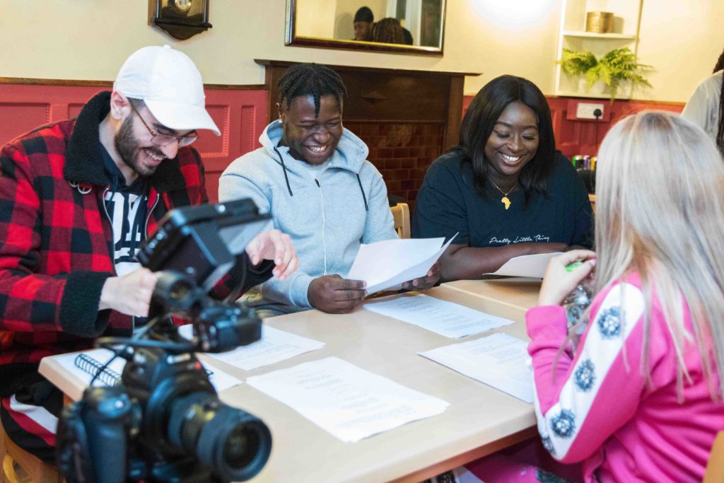 Cast of House 27 reading scripts on location