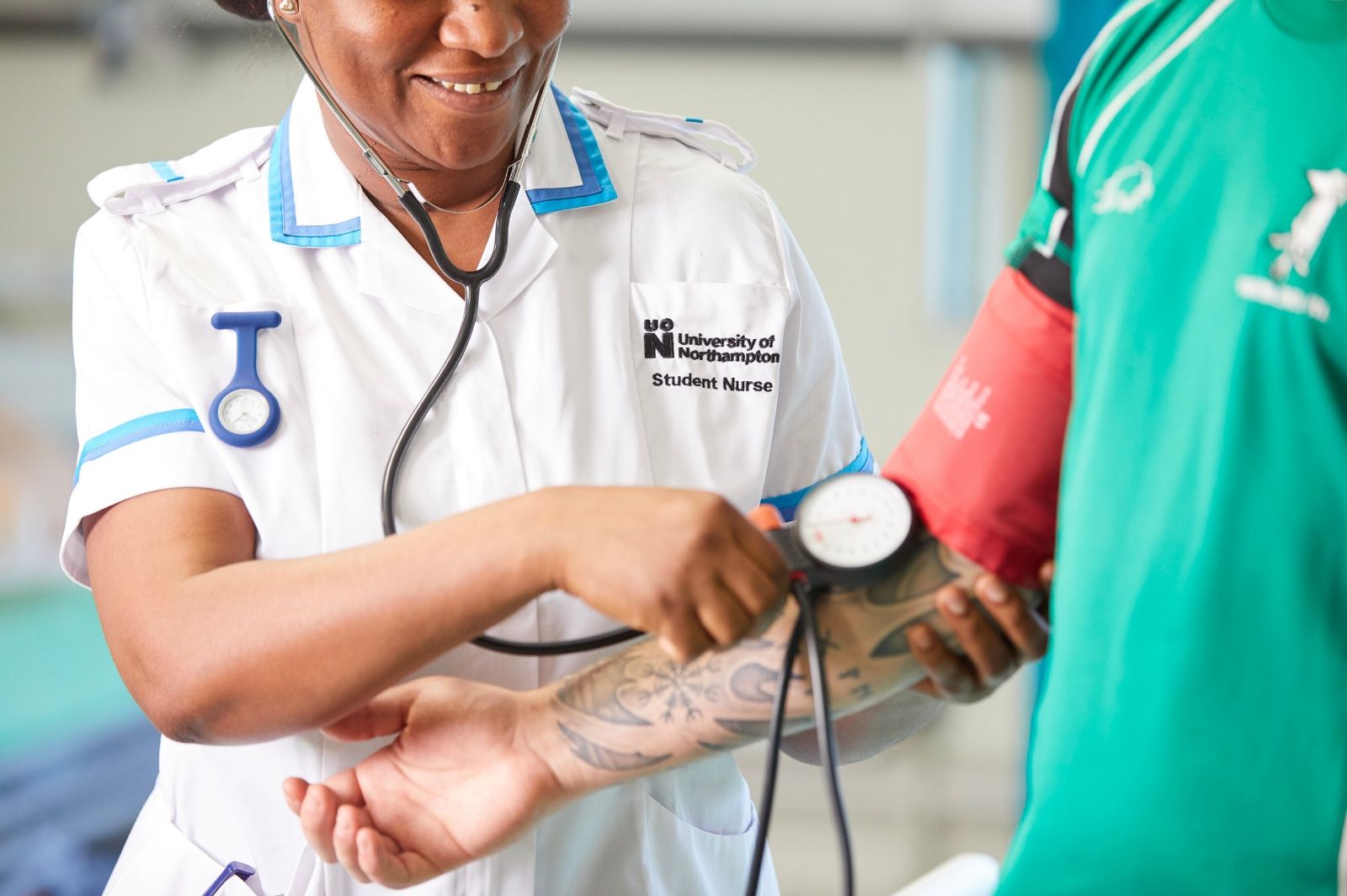 Nursing students taking a man's blood pressure