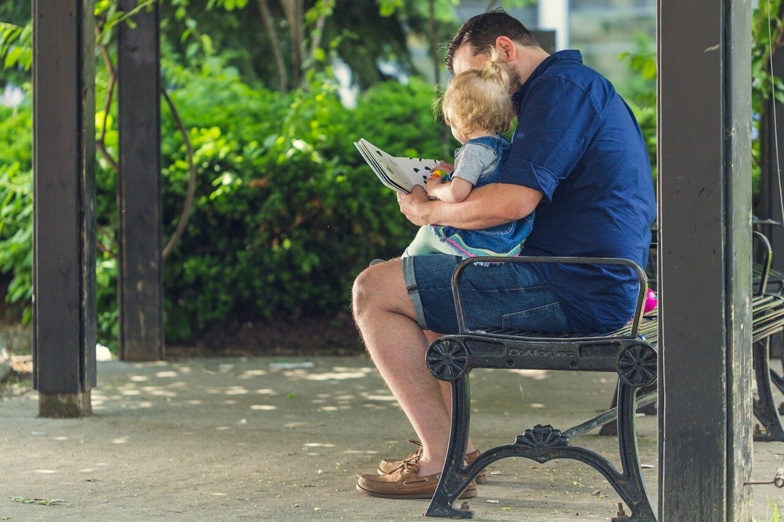 Image of a father and daughter reading together