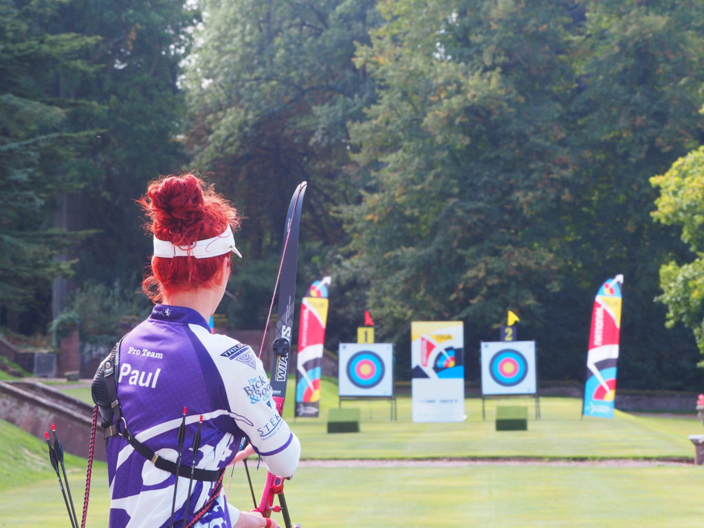 Ruby Paul facing an archery target