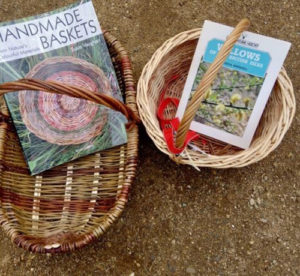 Two wicker baskets, with Handmade Baskets magazine inside