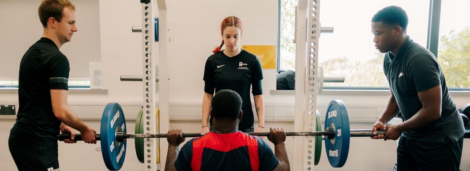 Students supporting another to strict press