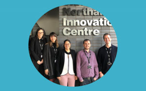 Research Innovation staff standing outside the Innovation Centre sign at the University of Northampton's Innovation Centre