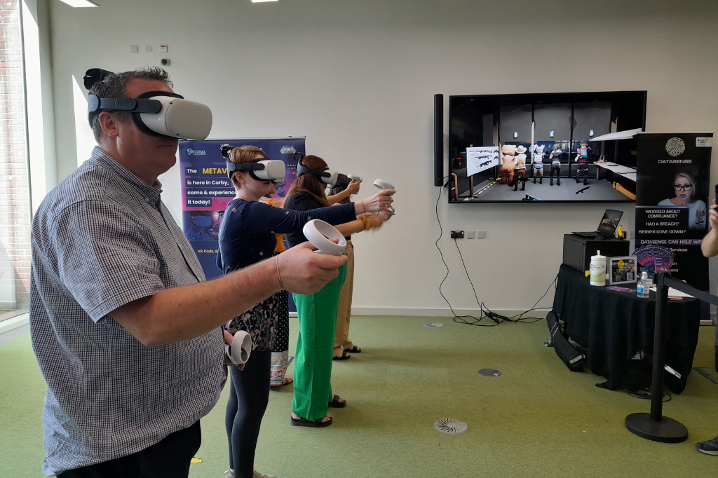 Photograph of five people wearing virtual reality headsets
