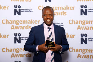 Abide Zenenga holding their Changemaker Special Achievement Award