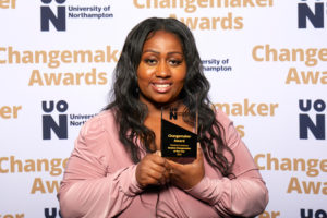 Charlene Cranstoun holding their Student Changemaker of the Year award