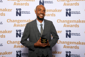 Marvin, of Lemonpop Workshops, holding their Changemaker Enterprise of the Year Award