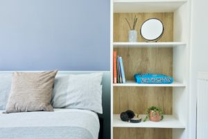 Bed and shelves in a Townhouse bedroom at Waterside