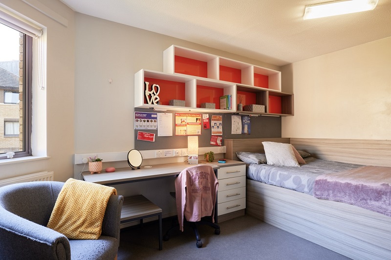 Armchair, desk and bed of single studio in Scholars Green halls