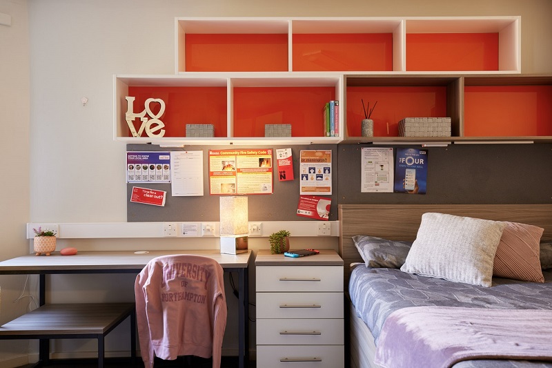 Desk and chair, and bed in single studio in Scholars Green Halls.