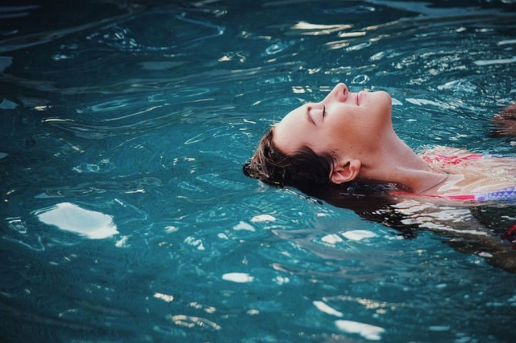 Woman floating in a pool
