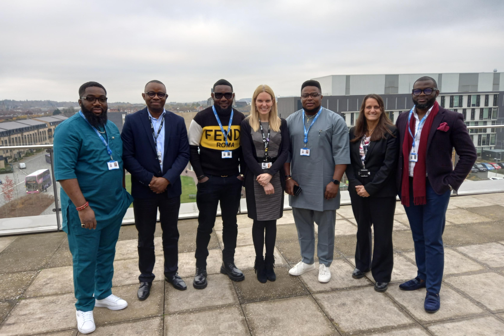 Group photo of university staff and Ayo Makun