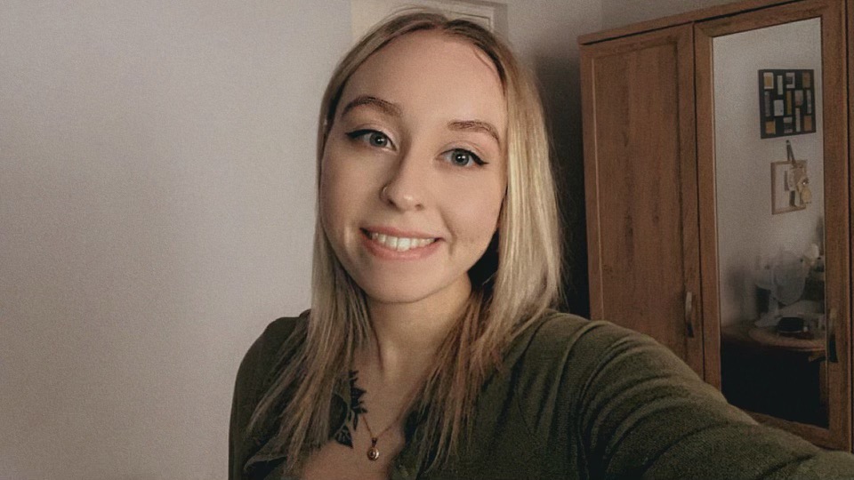 Emma Cowley, a Sociology student, smiling towards the camera. The photo is in a 'selfie' position, as her arm is off screen holding the camera.