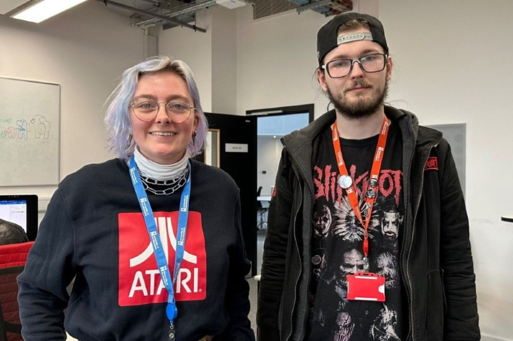 Two students pictured smiling at camera at Game Jam.