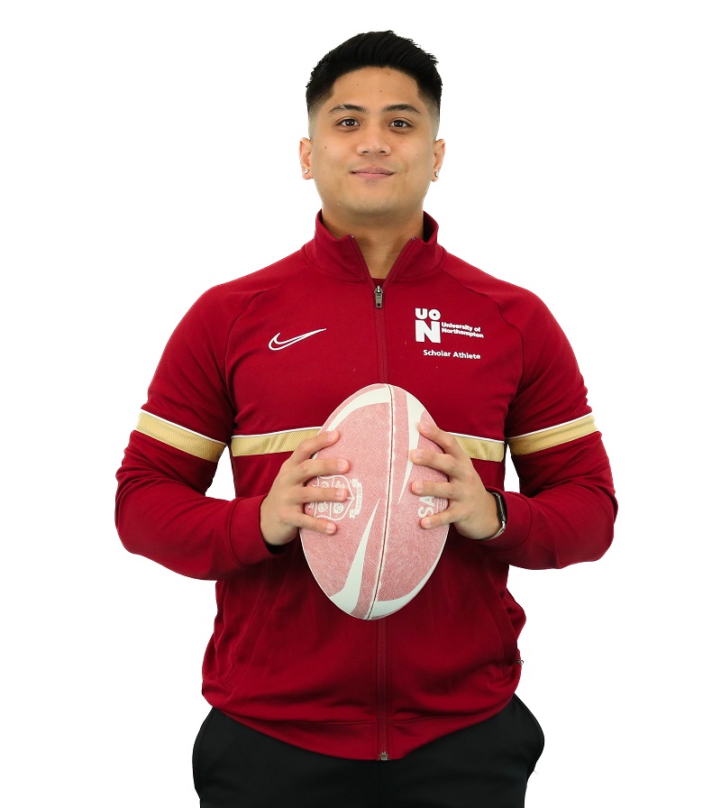 Jacob Solanga holding a rugby ball