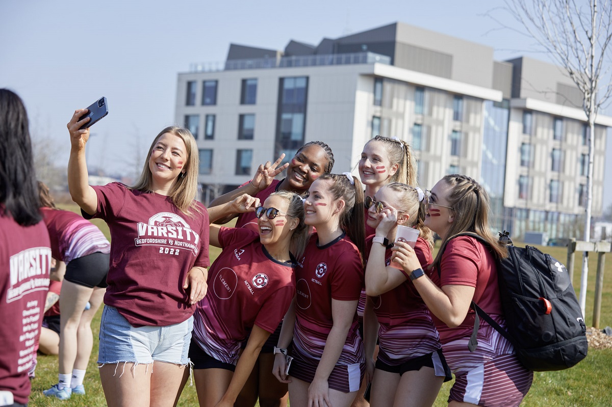 Group of female students wearing Varsity t-shirts take a selfie