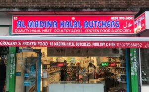 Outside the Al Madina Halal Afro Caribbean shop on Kettering Road. You can see inside the store, where there are people and filled shelves