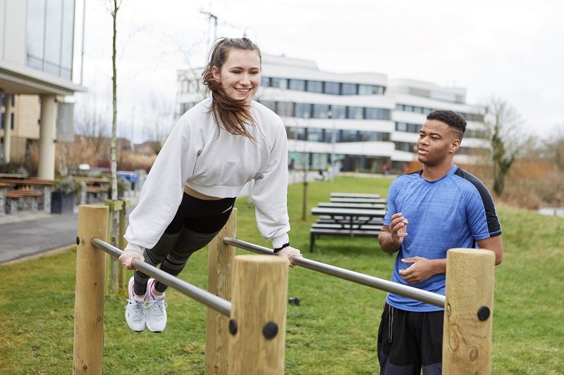 Student using parallel bars on UON's Trim Trail