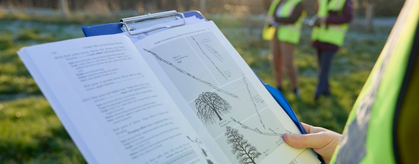 Student referencing book on field trip