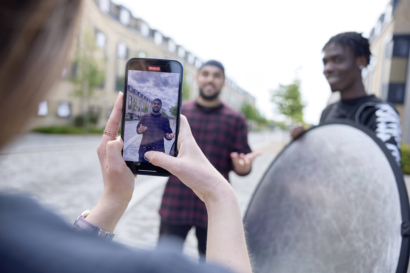 Student filming another student using a smartphone