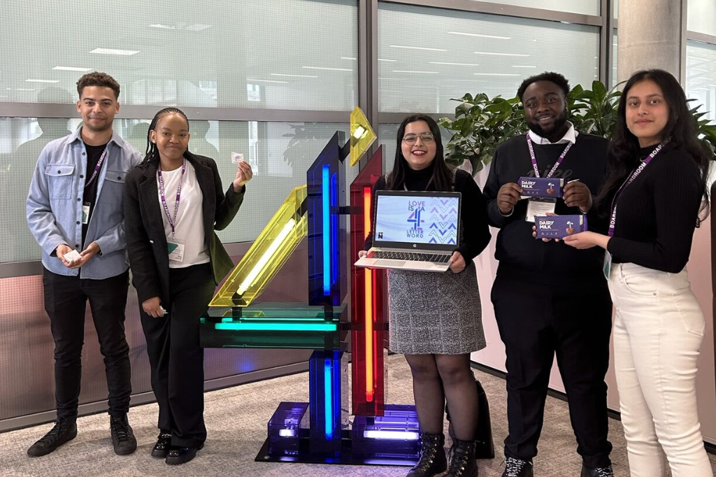 Group of five students stand next to Channel 4 logo.