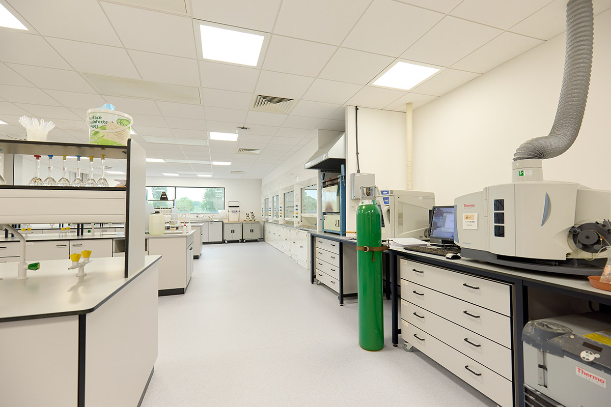 Internal view of the Chemical Testing Area in the Institute Creative Leather Technologies. It is a laboratory, with workbenches, gas taps, a gas cannister, and leather equipment around.
