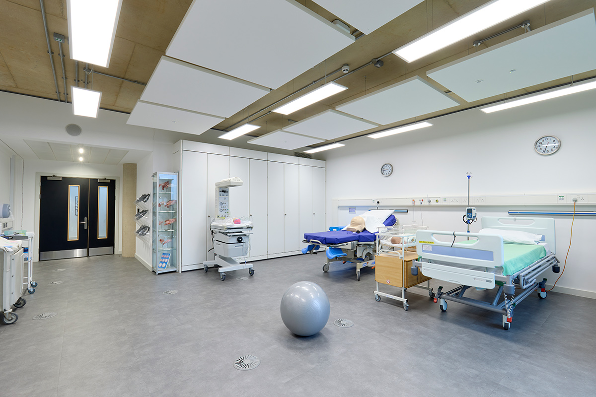 Internal view of the Midwifery suite, showing smaller ward beds, a birthing ball, and a midwifery room cot.