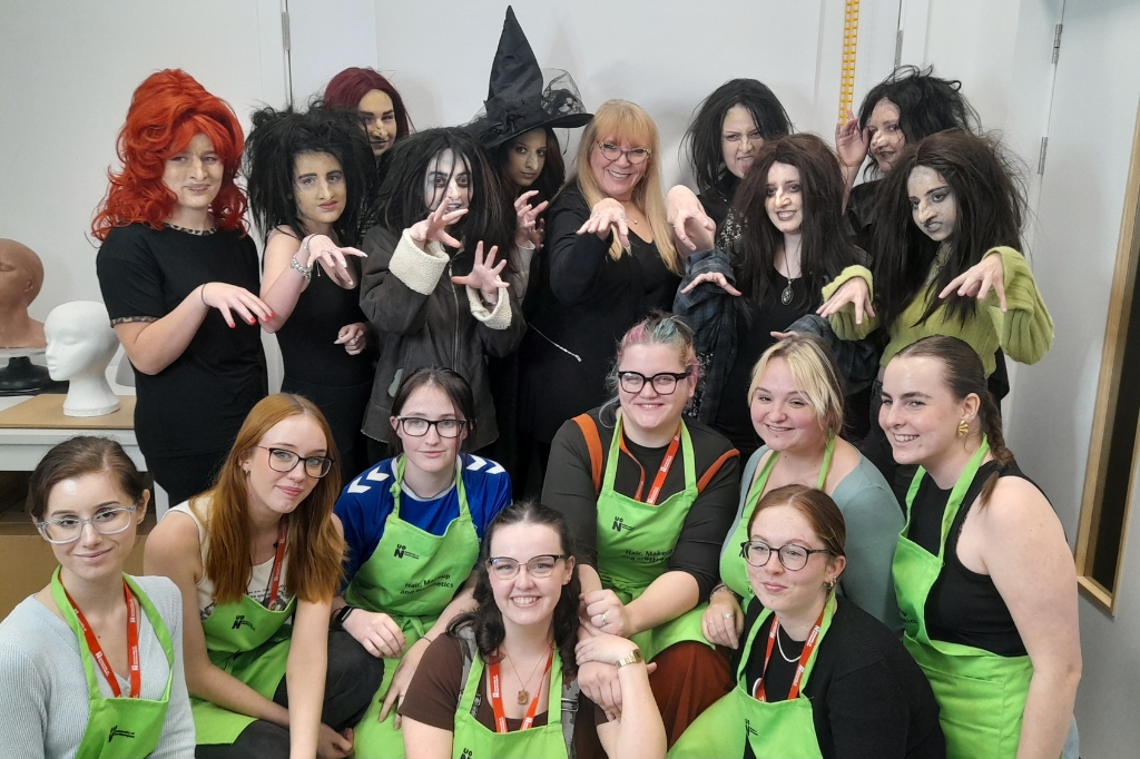 Group photo of Ve Neill and students with prosthetic witch make-up.