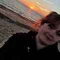 Profile picture of student Jessica Jade Maxey who is standing on a beach with the sun setting in the background