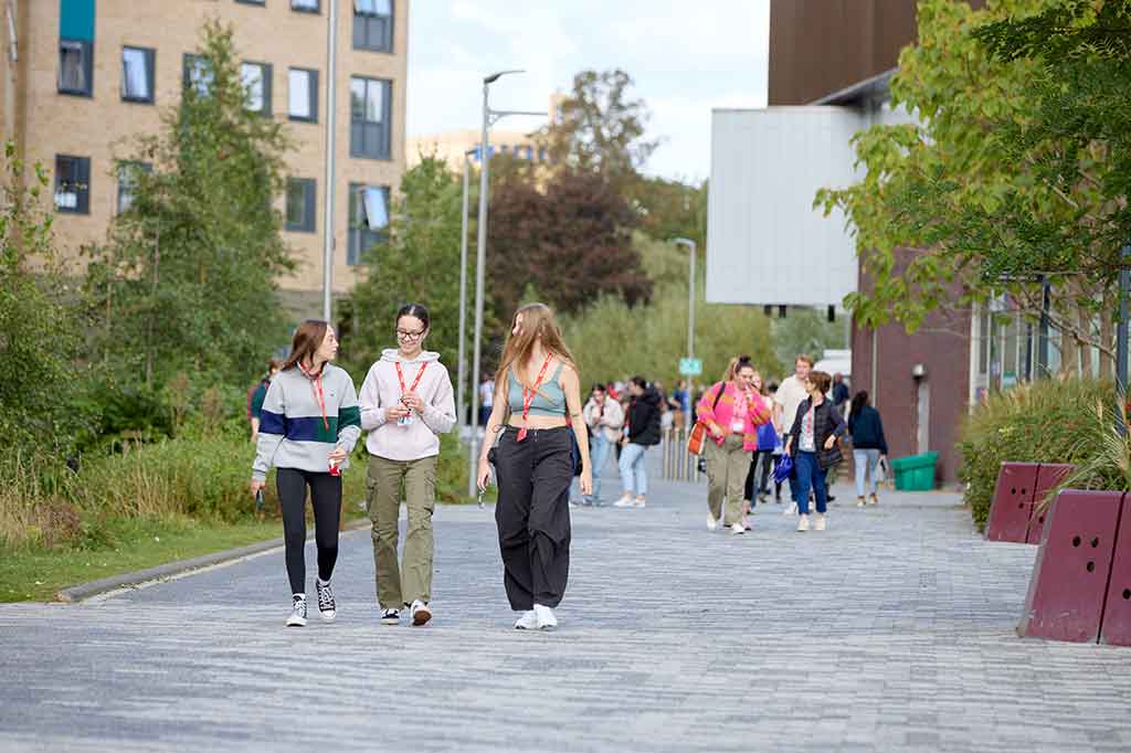 Three students walk round campus on their first day at University of Northampton