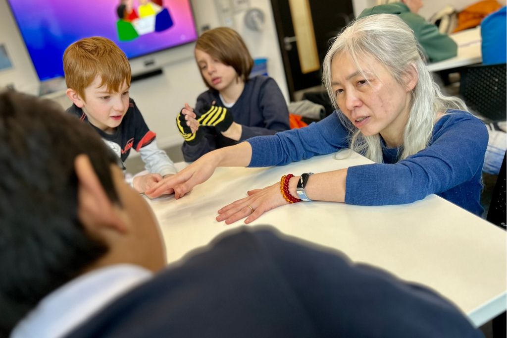 Senior Lecturer in Developmental and Educational Psychology Jo Chen Wilson helps students from Kingsley Primary understand eye tracking technology