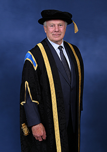 David Laing, the University of Northampton's Pro-Chancellor, is wearing ceremonial academic dress including a gown trimmed with gold, hood and cap with gold tassel