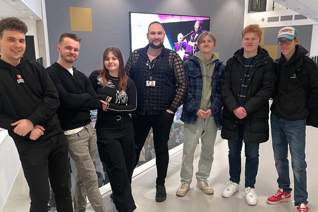 Group photo of six students and academic at Waterside campus.