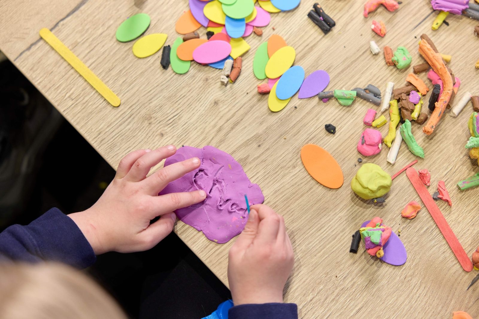 Child playing with plasticine