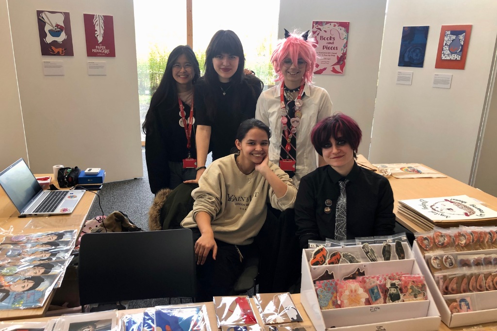 Group photo of students in front of exhibition stand at Learning Hub.