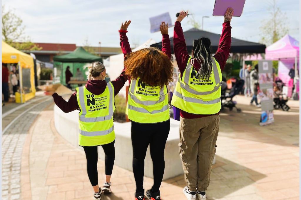 Hope Staines, Caitlyn Kemp-McKee and Denys Garcia celebrate at the end of their sucessful Fun Day at Rushden Lakes.