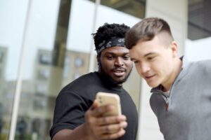 Two students looking at a smartphone.