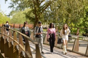 Students walking over the footbridge at Waterside campus