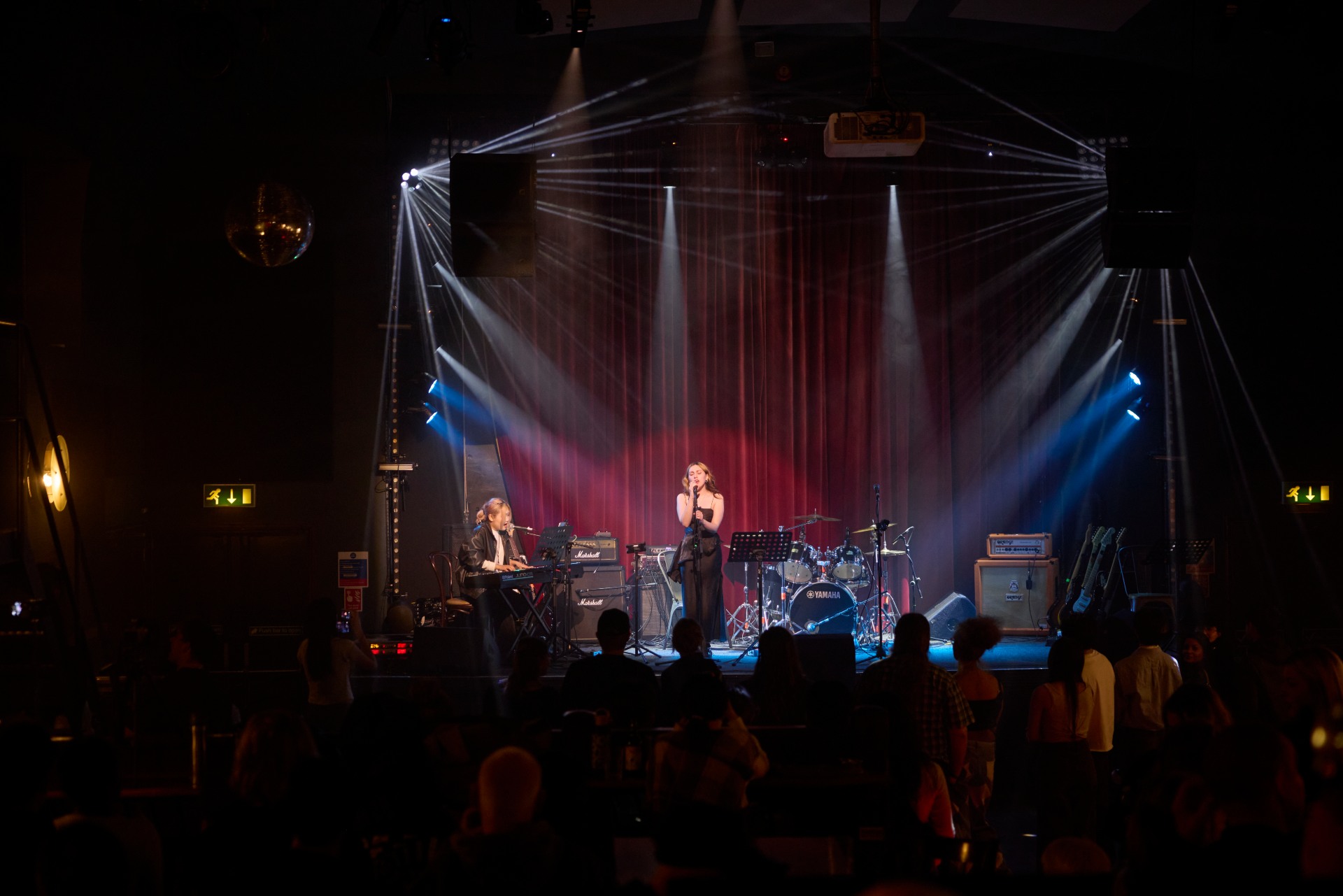 An image of the venue, Picturedrome Northampton, with a student on stage.