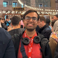 An image of Ishmam Yaseen Taha, student influencer stood in a crowd of people.