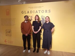Ishmam at a Gladiators Premiere with two women stood to his right.